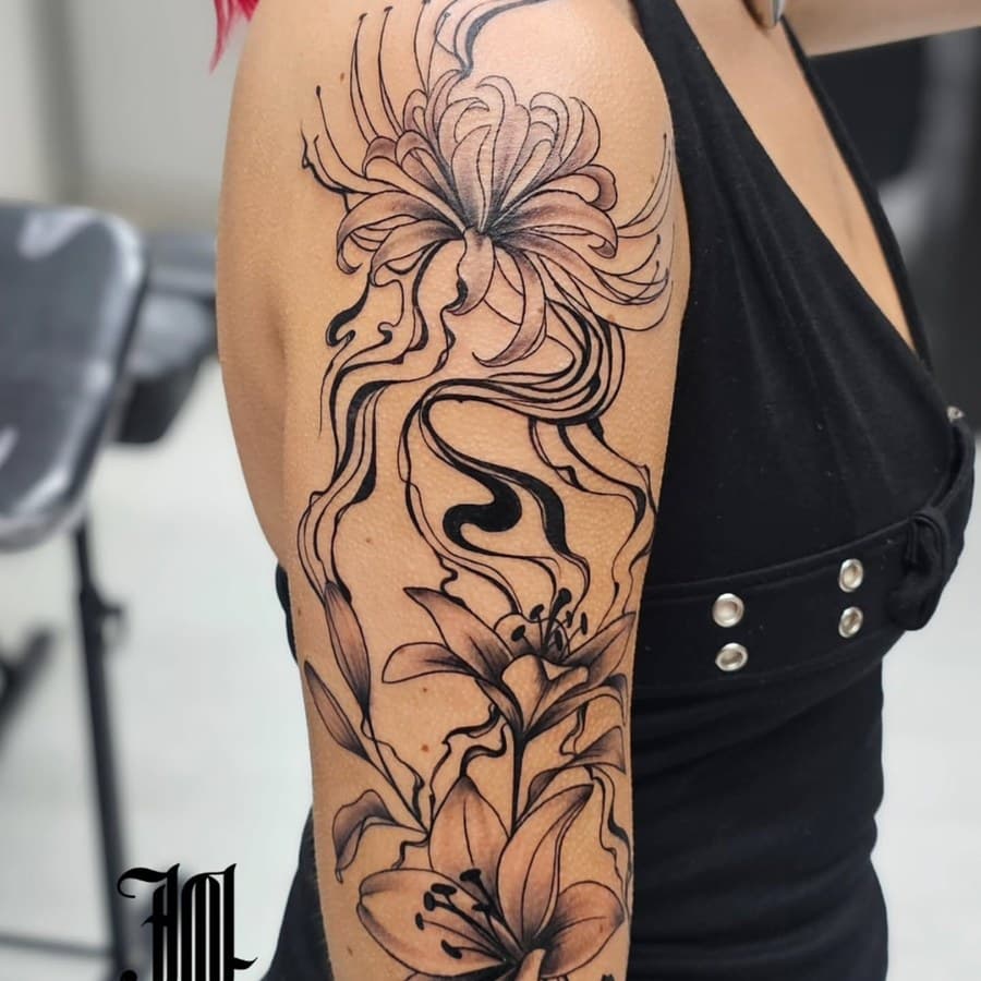 Black and grey chrysanthemum and lily sleeve on a shoulder